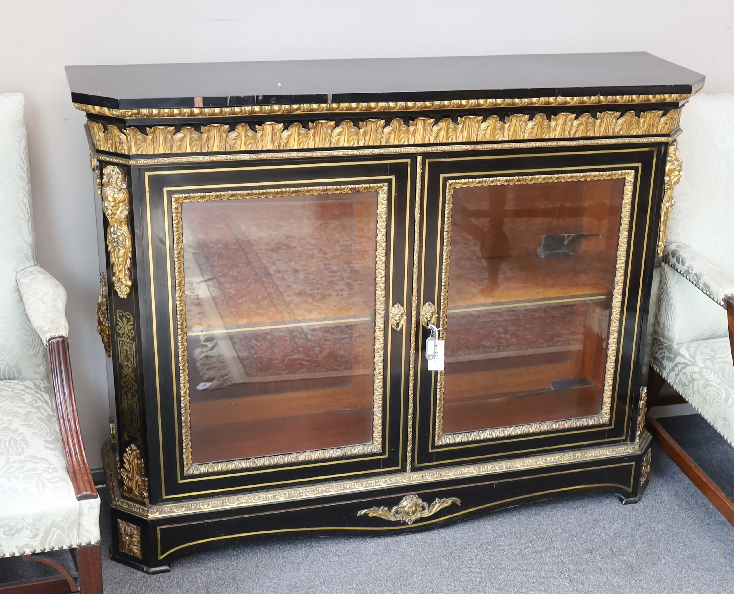 A 19th century French gilt metal mounted ebonised two door side cabinet, width 140cm, depth 38cm, height 107cm